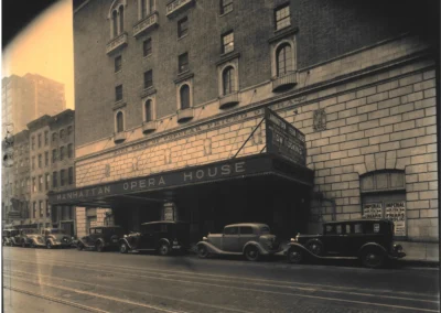 Early 20th-century street view of the Manhattan Center with vintage cars