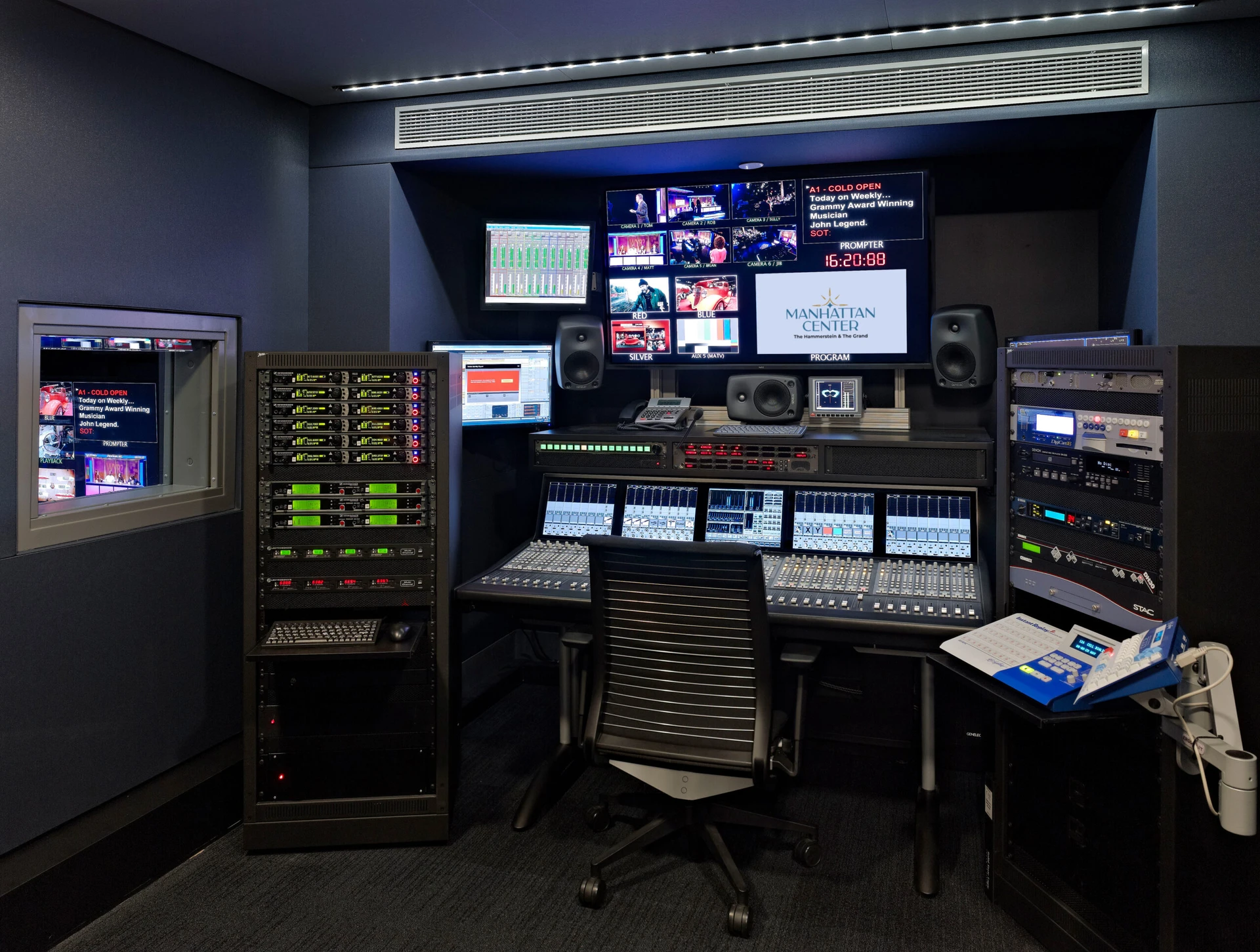 Studio 1 Audio room 2025-logo (1) A modern television control room featuring audio equipment, multiple screens, and a central mixing console, ready for production